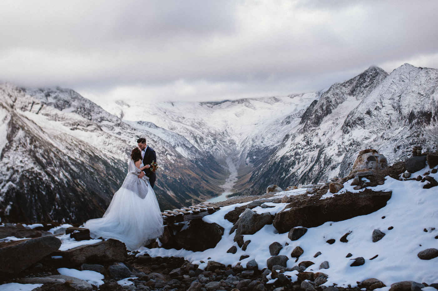 Bridal couple with mountain backdrop - Adventurous Elopement in Austria