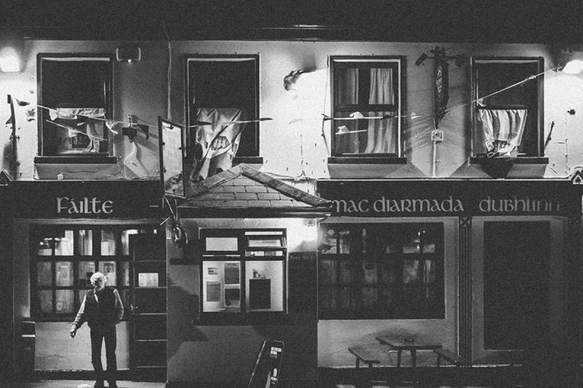 Irishman stepping out of a pub in Doolin