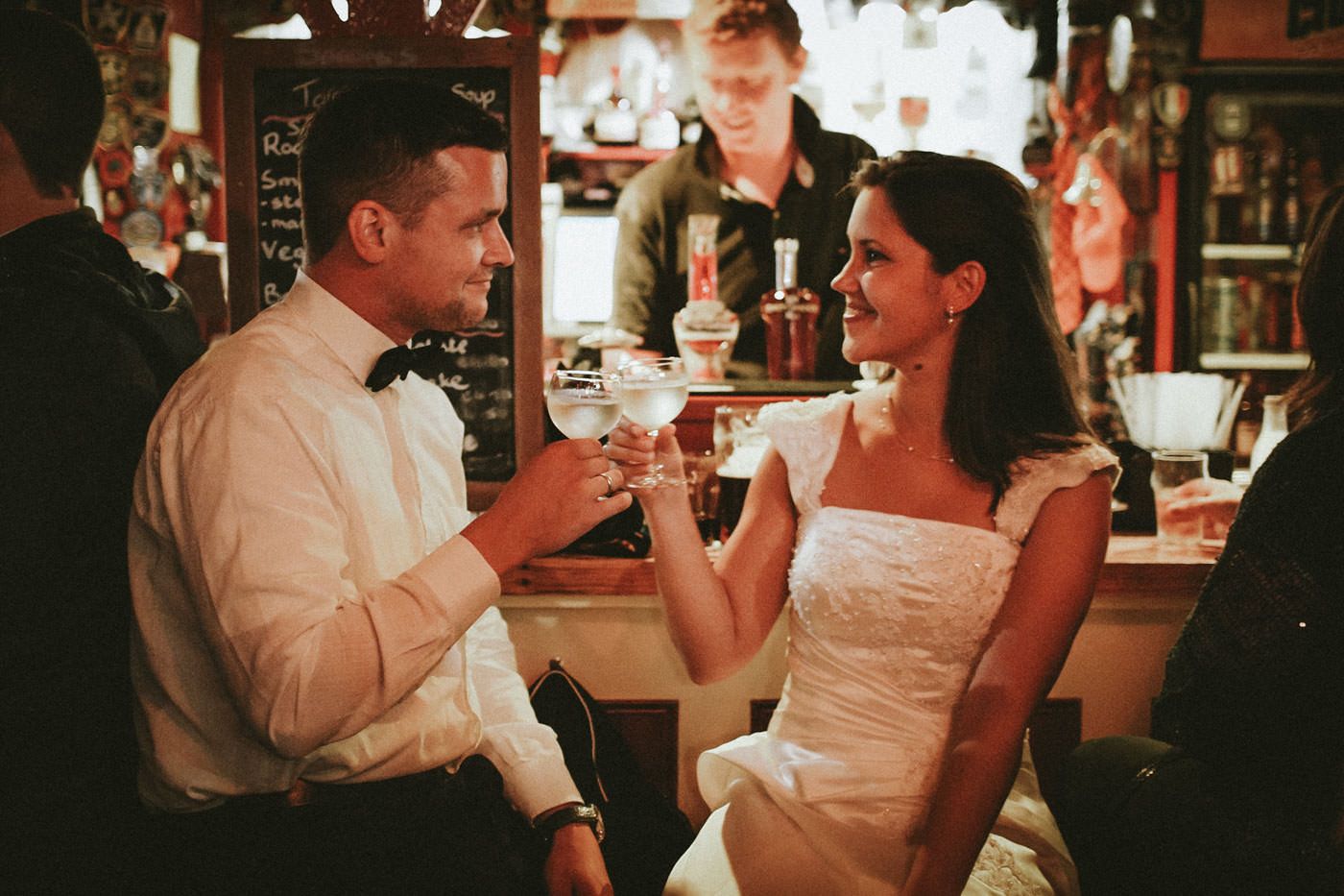 Bride and groom sipping on a glass of Champagne at the bar in McDermott's Doolin