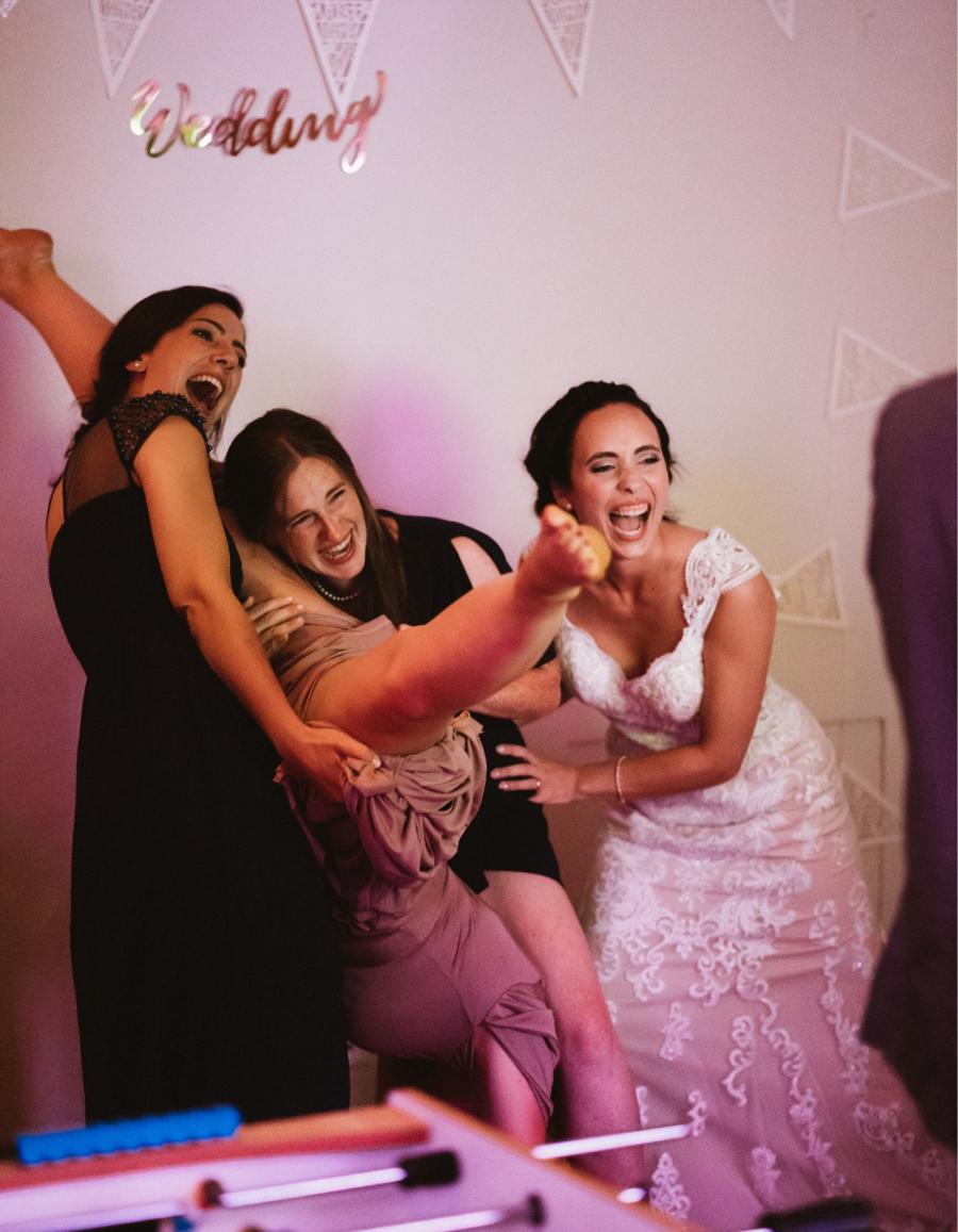 Bride and friends have fun in the photobooth at a wedding in Hornbach Abbey