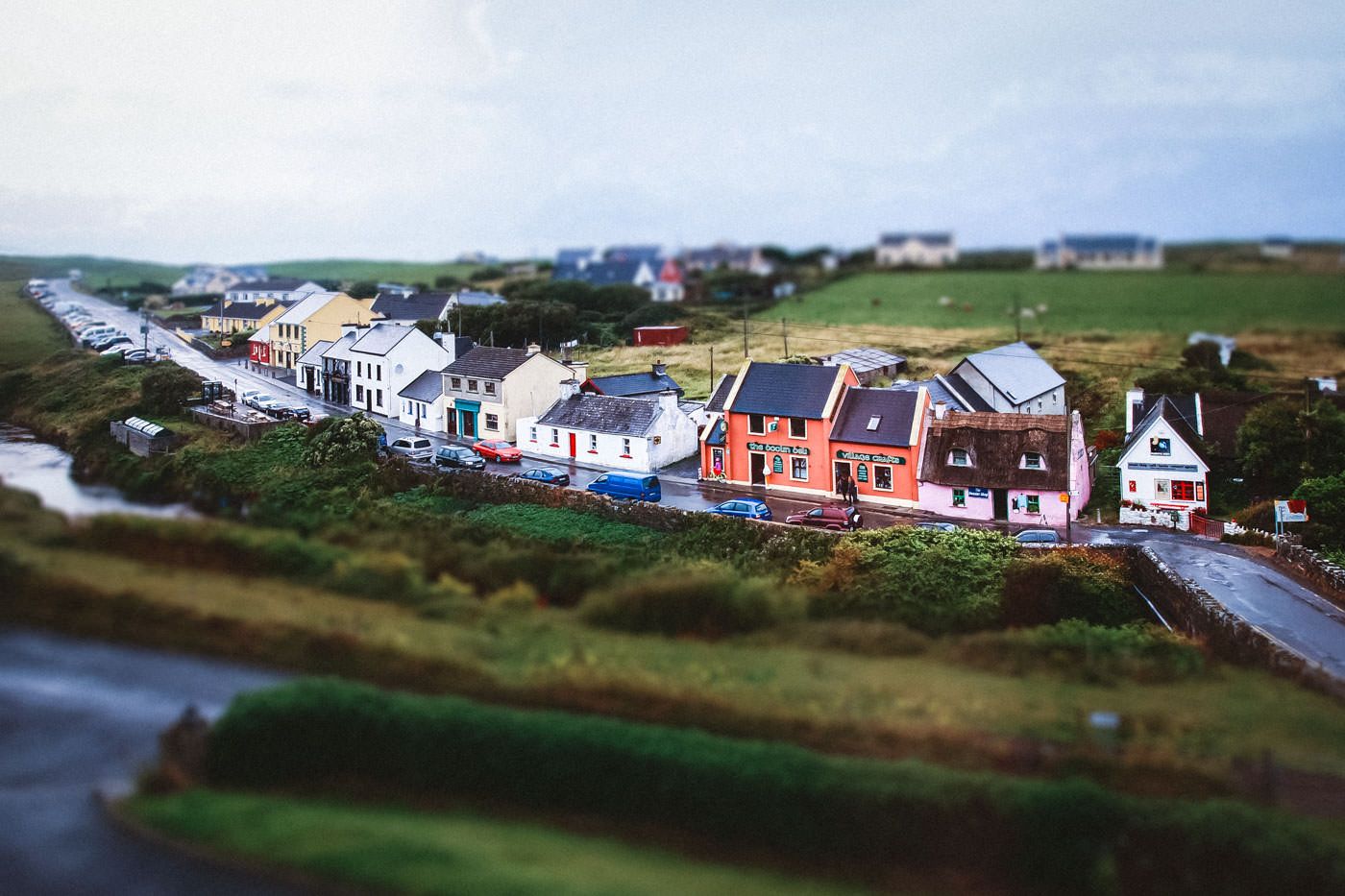 Colourful Fisher Street in Doolin - with pink Sweater Shop on the right and O'Connor's Pub on the left