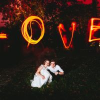 Wedding photo with Lightpainting in the park of the Juliusspital, couple with lightpainted "Love" in the background - Wedding Photographer Wuerzburg BRAUTRAUSCH®