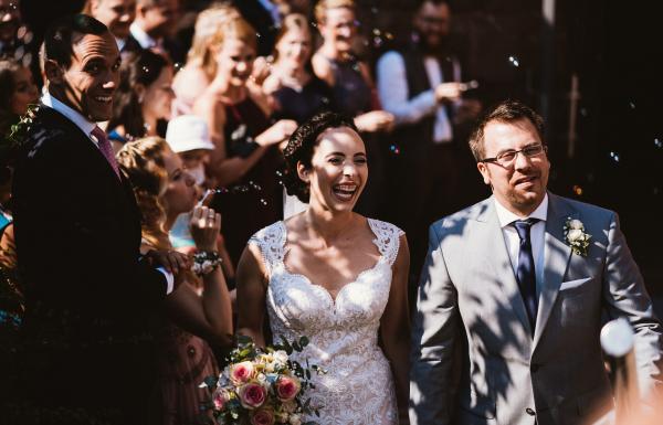 Bridal couple leaving after their wedding ceremony at St Fabian's Monastery in Hornbach
