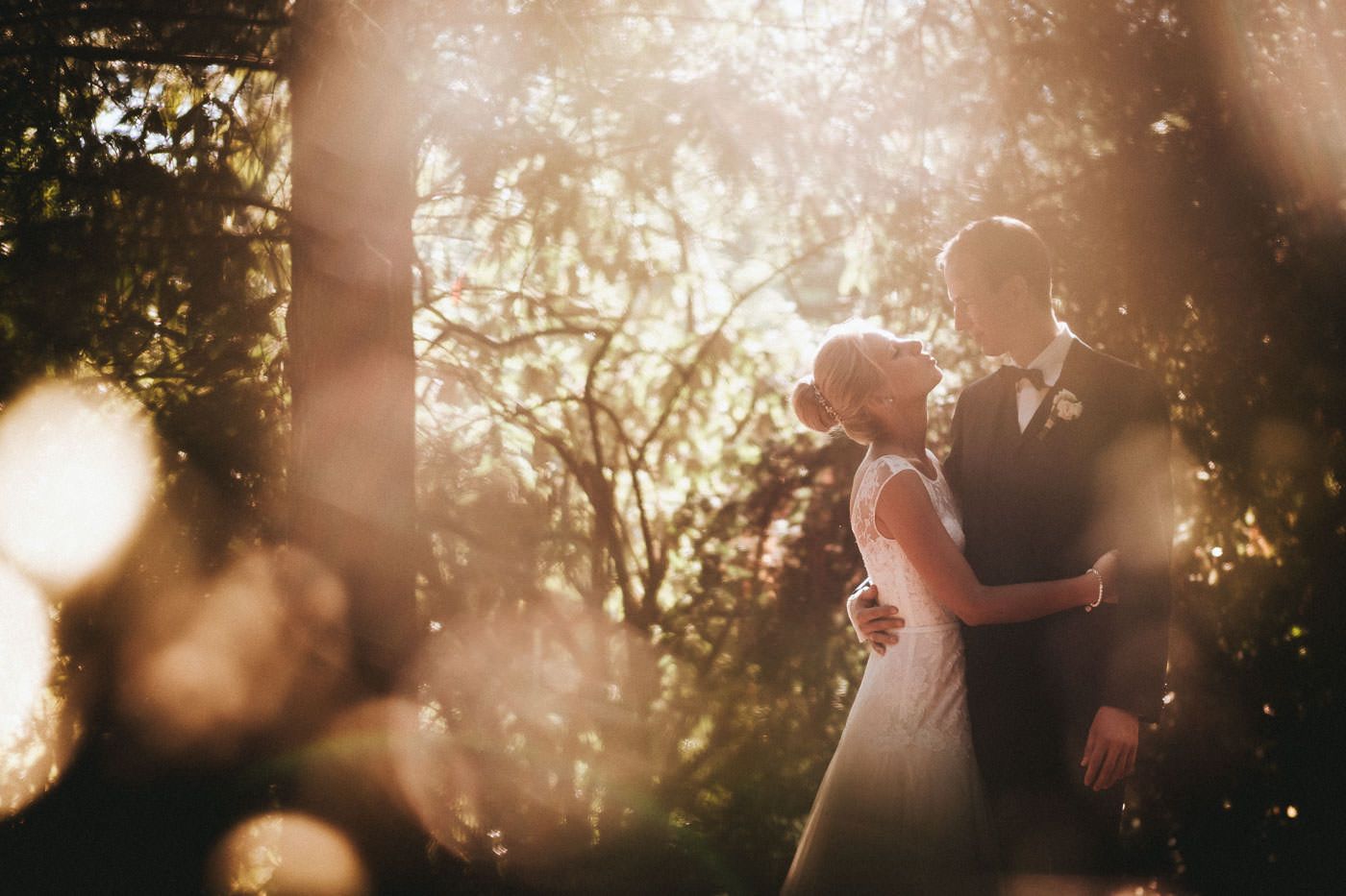 Bride and groom backlit looking at each other, wedding photos in Bad Homburg spa park