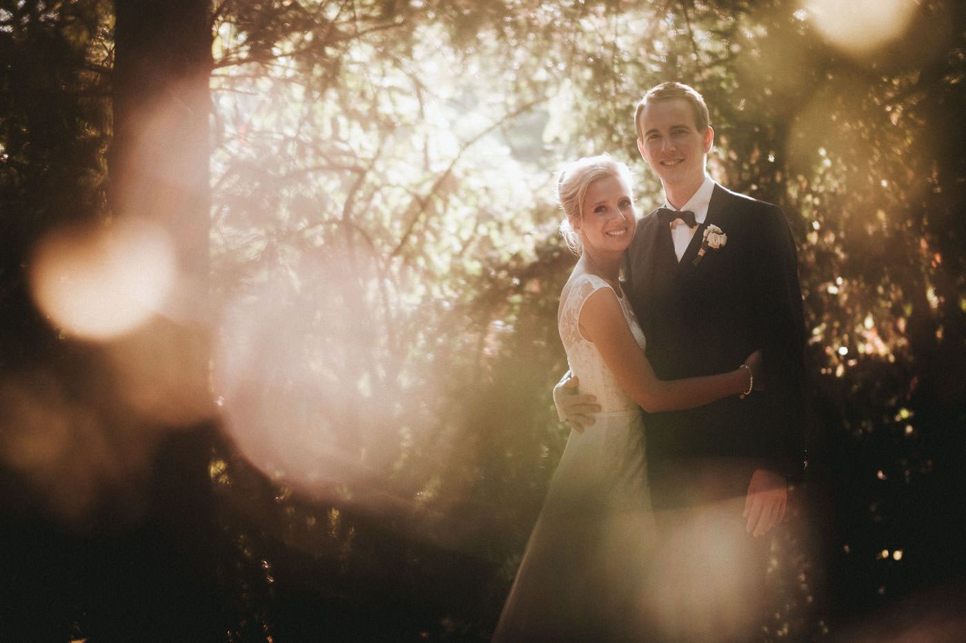 Bride and groom backlit looking at the camera, wedding photos in Bad Homburg spa park